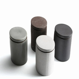 Neutral modern countertop storage containers with textured finish.
