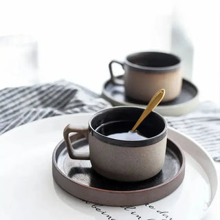 Miri stoneware mug and saucer set with spiral pattern in speckled oatmeal glaze, styled for modern and rustic tableware. Perfect for milk, tea, or coffee.