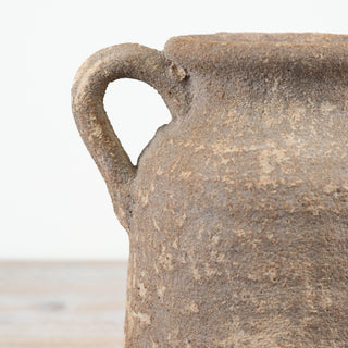 Textured rustic vase with aged finish and sculptural form.
