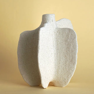 The Pontus Ceramic Vase, a decorative vase inspired by marine life, featuring an organic, coral-like shape with intricate textures and a matte off-white finish. This sculptural piece captures the fluidity of ocean waves, making it a perfect accent for coastal, Japandi, and minimalist interiors. Ideal as a standalone art piece or for dried floral arrangements.