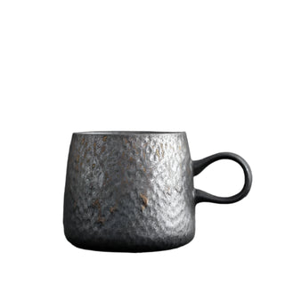 Handmade stoneware mug with a bronze metallic glaze, inspired by wabi-sabi aesthetics.