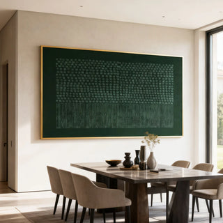 Large green abstract painting on the wall above a wooden dining table.