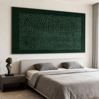 Large textured wall art in a minimalist bedroom.