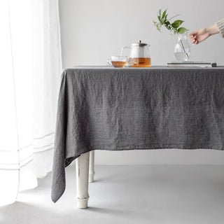 Charcoal grey linen tablecloth with textured drape.