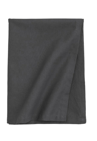 Handmade dark grey cotton tablecloth with soft texture and elegant drape, styled for a modern, minimalist dining setting.