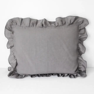 Ruffled linen standard pillowcase in dark grey, made from 100% flax linen, styled on a soft neutral bed – available in multiple colours and sizes from Arkaim Home.