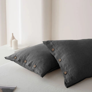 Close up of dark grey linen pillows with coconut buttons. Perfect for modern, minimalist, scandi or boho bedrooms.