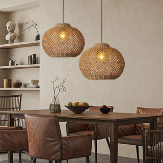 Handwoven seagrass pendant lights with rounded dome shape, hanging over a wooden dining table - perfect for contemporary, minimalist decor.