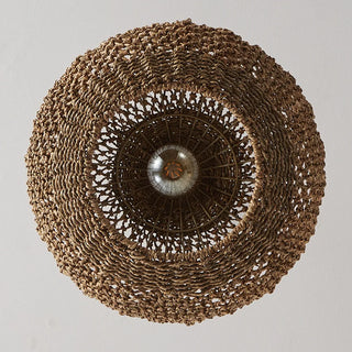 Handwoven seagrass pendant light with an open, rounded bell shape, showcasing natural texture and warm woven detailing.