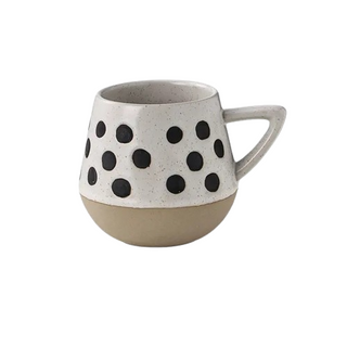 Nordic-inspired handmade clay mug with a white satin-speckled glaze and a dotted motif, perfect for tea or coffee.