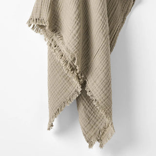 Close-up of six-layer gauze texture with soft fringe edges.