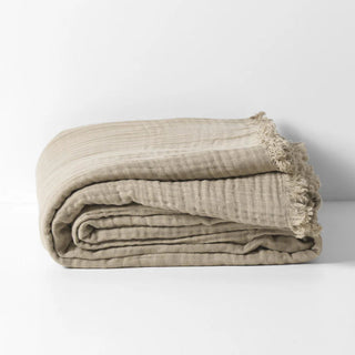 Lightweight cotton throw folded neatly with visible gauze layers.
