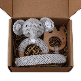 Handmade baby gift set with crochet elephant rattle, wooden teether, and pacifier clip in natural cotton and beechwood.