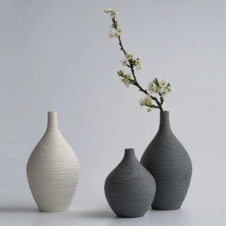 Modern ceramic flower black and white vases from the Emi Vases collection, featuring a sleek, minimalistic design with ribbed texture. Crafted from high-quality ceramic, these vases enhance contemporary, minimal or scandi home décor with their sculptural elegance. Perfect for displaying as a standalone piece or grouped together on a shelf or console, they add sophistication and refinement to any room.
