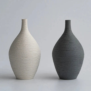 Modern ceramic flower black and white vases from the Emi Vases collection, featuring a sleek, minimalistic design with ribbed texture. Crafted from high-quality ceramic, these vases enhance contemporary, minimal or scandi home décor with their sculptural elegance. Perfect for displaying as a standalone piece or grouped together on a shelf or console, they add sophistication and refinement to any room.