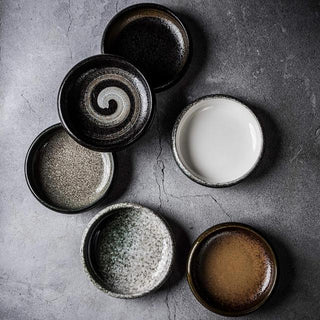 Japanese-inspired artisanal coupe plates with hand-painted glaze, earthy tones, and a matte finish, ideal for gourmet dishes or modern plating.