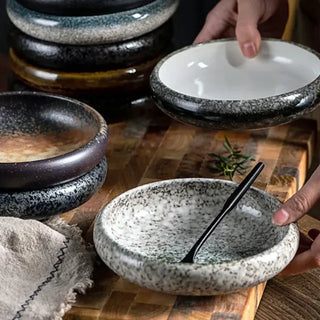 Japanese-inspired artisanal coupe plate with hand-painted glaze, earthy tones, and a matte finish, ideal for gourmet dishes or modern plating.