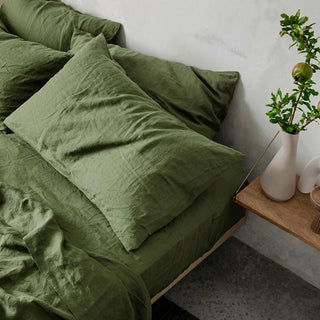 Forest green pure linen bedding set, includes flat and fitted sheets and two pillowcases. Natural pre-washed flax linen bedding, textured and soft, ideal for year-round comfort. Perfect for modern, Boho, Scandinavian, and wabi-sabi bedroom styles.