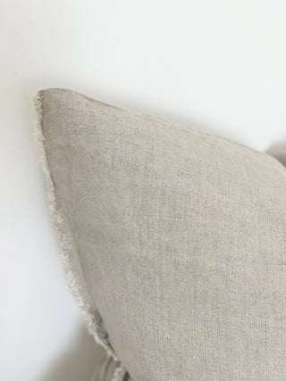 Textured linen cushion in warm neutral tones for sofas, beds and layered interiors.