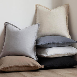 Fringed cotton throw pillows in neutral earthy colours. Perfect for layering on sofa or bed.