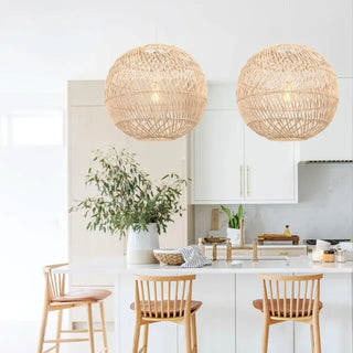 Handwoven natural rattan globe pendant lights above a kitchen breakfast bar, ideal for Boho, coastal, or Scandinavian interior lighting.