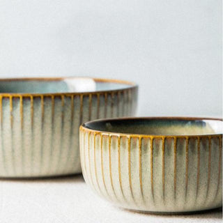 Kiln-glazed ceramic bowls with ribbed surface and earthy, neutral tones inspired by sand and sea—ideal for serving rice, noodles, or shared meals.
