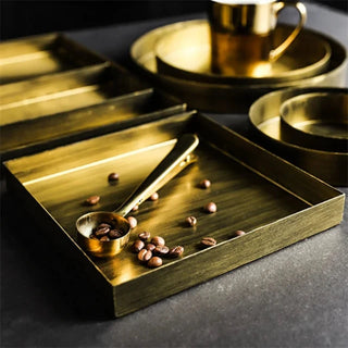 Elegant decorative gold metallic serving trays with a brushed finish, perfect for natural homeware enthusiasts. These stylish trays add a touch of sophistication to any kitchen or dining setup. Ideal for serving drinks, displaying candles, diffuser, flower vase, or creating a striking base for a captivating centrepiece.