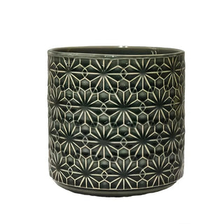 Green ceramic kitchen utensil holder with embossed floral pattern.