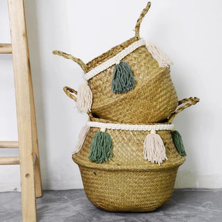 Handwoven natural seagrass storage basket with handles, perfect as a stylish hanging basket, pot planter, or decorative storage solution. This eco-friendly basket, adorned with charming tasselled fringe, adds a natural boho touch while keeping your space organized. Shop handcrafted storage baskets at our natural homeware store.