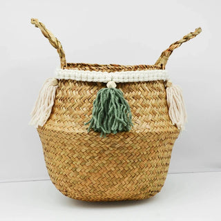 Handwoven natural seagrass storage basket with handles, perfect as a stylish hanging basket, pot planter, or decorative storage solution. This eco-friendly basket, adorned with charming tasselled fringe, adds a natural boho touch while keeping your space organized. Shop handcrafted storage baskets at our natural homeware store.