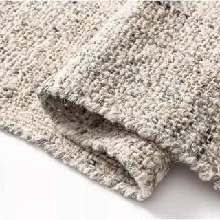 Grey Nordic handmade wool and jute rug with a natural, heathered texture in neutral tones—ideal for minimalist and earthy home décor.