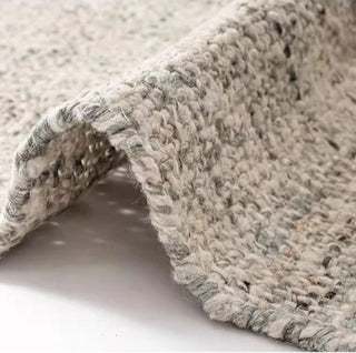 Grey Nordic handmade wool and jute rug with a natural, heathered texture in neutral tones—ideal for minimalist and earthy home décor.