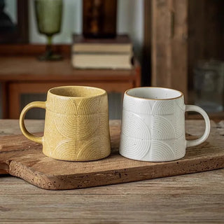 Textured white and ochre ceramic tea mugs Arkaim Home in rustic kitchen