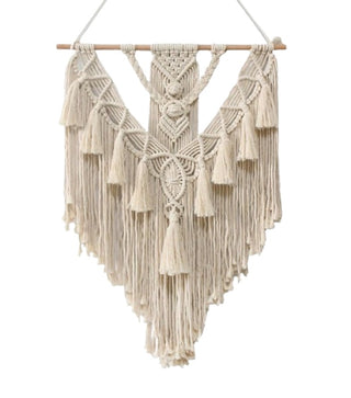 Handmade tasselled macramé wall hanging in natural cotton.