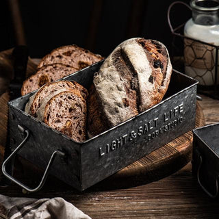 Handmade black rustic iron metal serving tray with handles, perfect for kitchen and pantry storage. This versatile bread box-style tray adds a vintage touch to homeware collections, ideal for serving, organizing, or decorative display. Crafted from natural materials for a timeless, functional aesthetic.