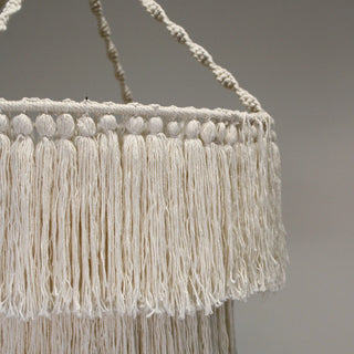 Natural cotton rope chandelier with layered tassel detailing and soft, tactile texture.