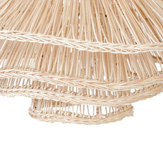 Natural handwoven rattan pendant light with organic, wave-like shape and soft ambient glow, ideal for boho and modern interiors.