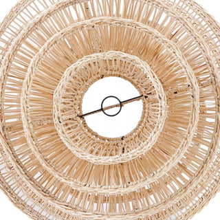 Natural handwoven rattan pendant light with organic, wave-like shape and soft ambient glow, ideal for boho and modern interiors.