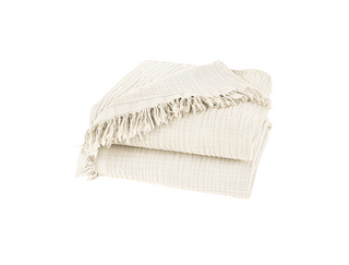 Nori Ivory Cotton Gauze Throw – soft and lightweight natural blanket with textured weave and fringed edges. Perfect for layering over a bed or sofa for a relaxed, cozy and lived-in look.