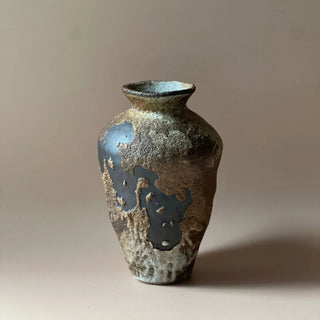 Rustic handmade ceramic vase for console or shelf styling.