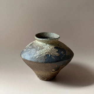 Rustic handmade ceramic vase for console or shelf styling.