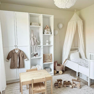 White cotton nursery canopy with a conical top and draped fabric, ideal for creating a cosy reading nook or dreamy play space in a child's room.