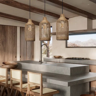 Row of seagrass pendant light hanging above a kitchen island.