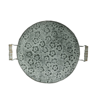 Round floral embossed galvanized iron tray, a stylish metal serving plate with handles perfect for kitchen tableware. This durable serving plate features intricate embossing, adding a touch of elegance to your dining experience. Ideal for both practical use and natural home decor, it enhances your table setting with rustic charm and versatility.
