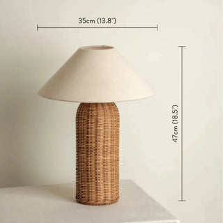 Wicker table lamp with beige linen lampshade with dimensions displayed.