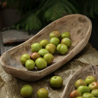 Handcrafted Kodai tray made from natural Paulownia wood, featuring a rustic boat-shaped design that showcases organic beauty. This decorative and practical accessory adds texture and character to any setting, perfect for displaying fruit, trinkets, potpourri, or holiday ornaments. A unique piece for natural home décor.