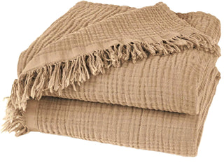 Nori Latte Cotton Gauze Throw – soft and lightweight natural blanket with textured weave and fringed edges. Perfect for layering over a bed or sofa for a relaxed, cozy and lived-in look.