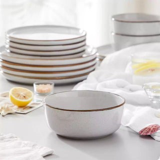 Light grey stoneware dinner set with dinner plates, side plates and bowls.
