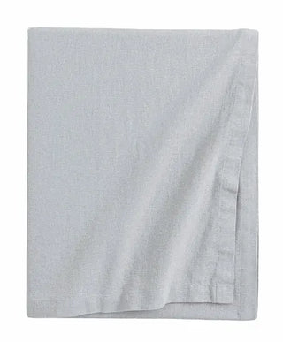 Handmade light grey cotton tablecloth with soft texture and elegant drape, styled for a modern, minimalist dining setting.