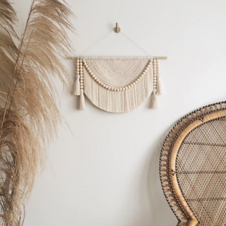 Handmade macrame wall hanging – a beautifully crafted natural home decor piece. Featuring intricate knot patterns and wooden bead tassel details, this boho-inspired wall art adds texture and warmth to any space. Perfect for modern, rustic, or Scandinavian interiors. Ideal for living rooms, bedrooms, or entryways. 